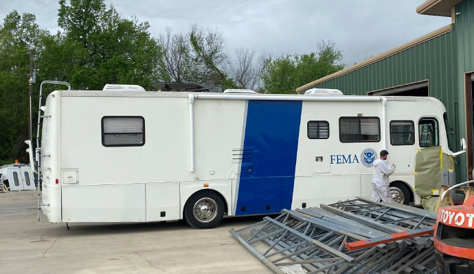 Person repairing RV siding